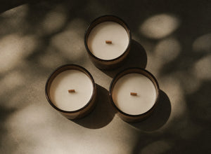 A grounding candle and calming room spray arranged for an evening reset ritual.