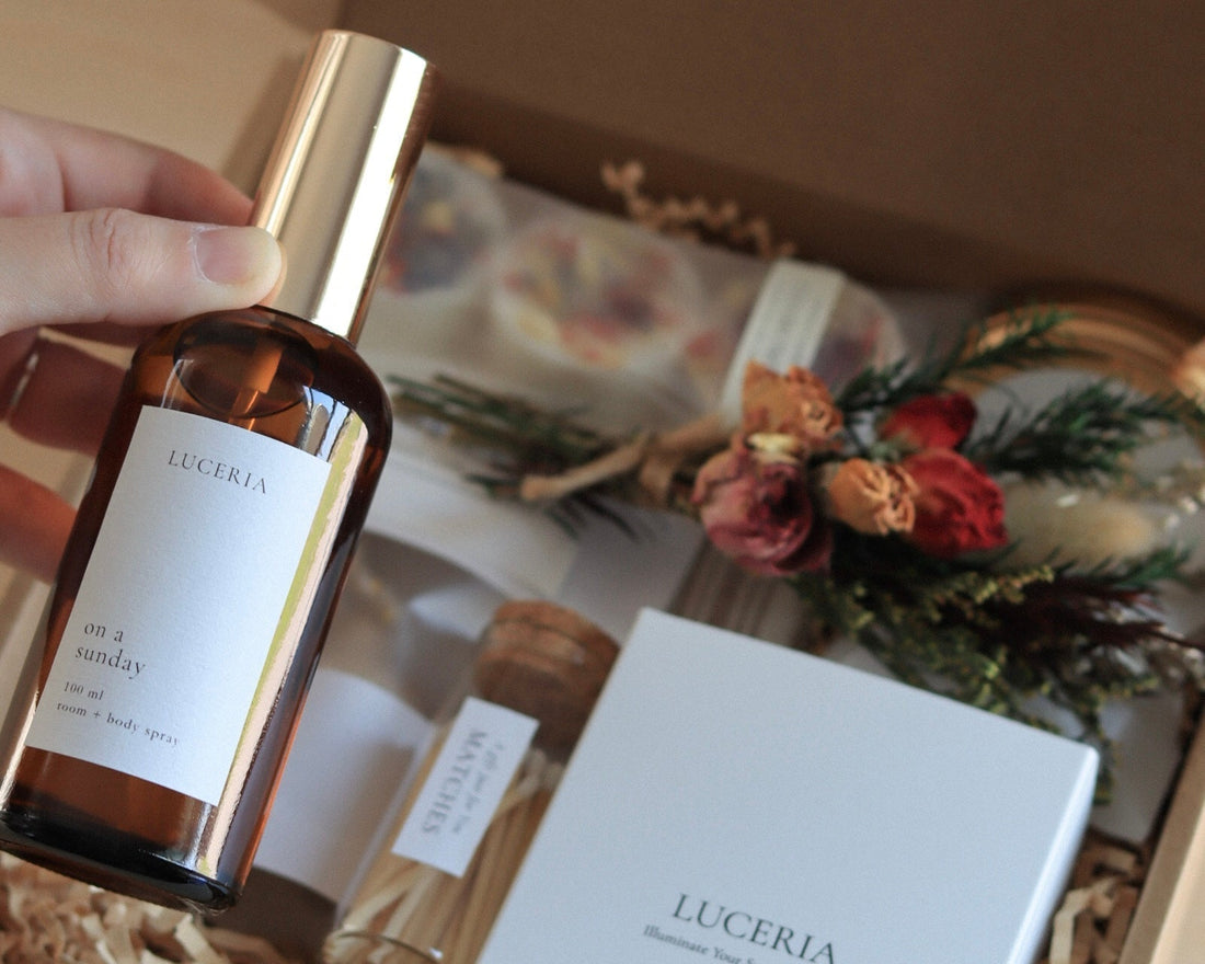 Luceria curated gift box with candle, mist, and wax melts on warm-toned surface.