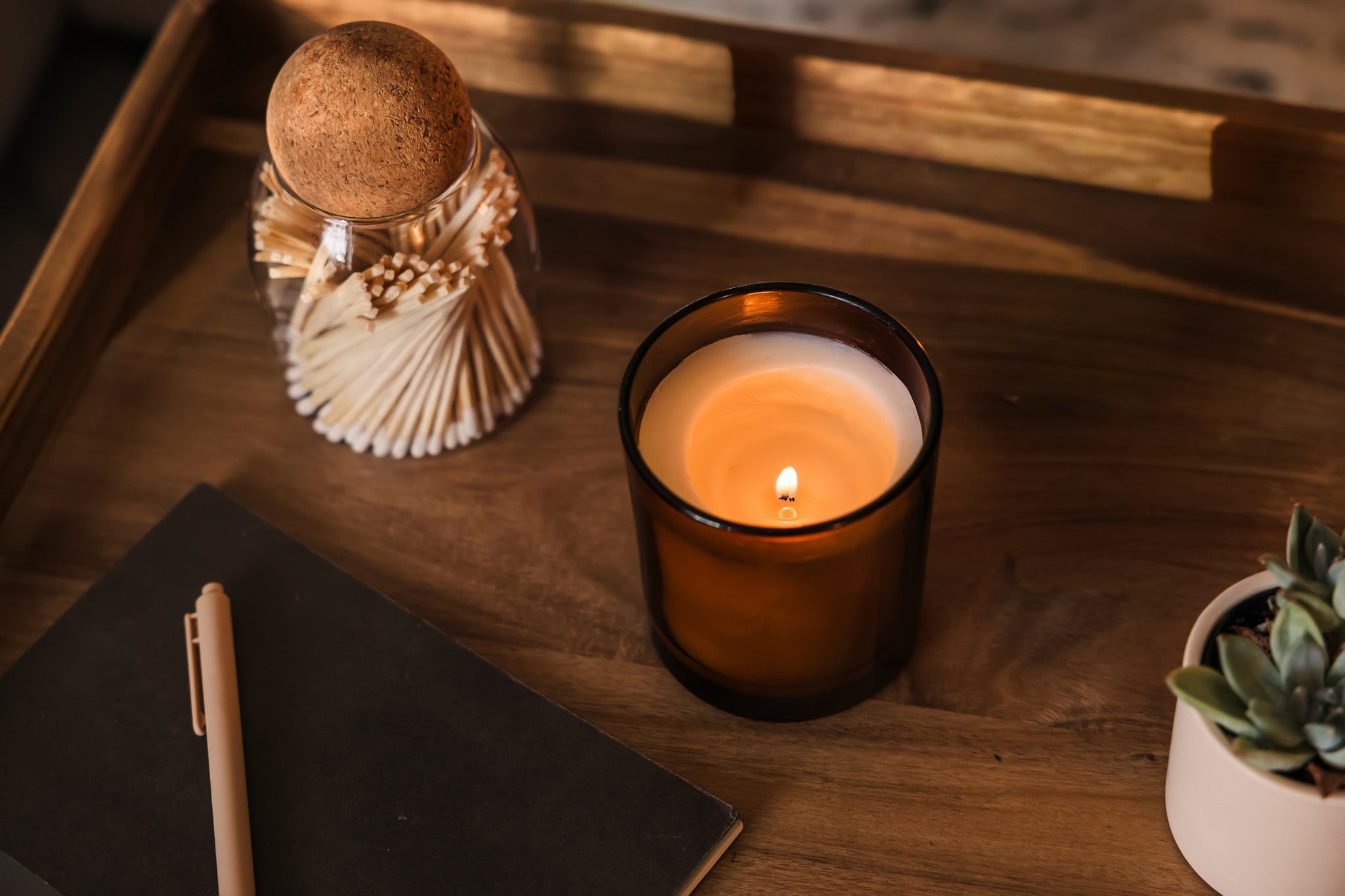 Luceria blog: Why do scented candles give me headaches featuring a candle lit with Fraser sprig and wooden wick.