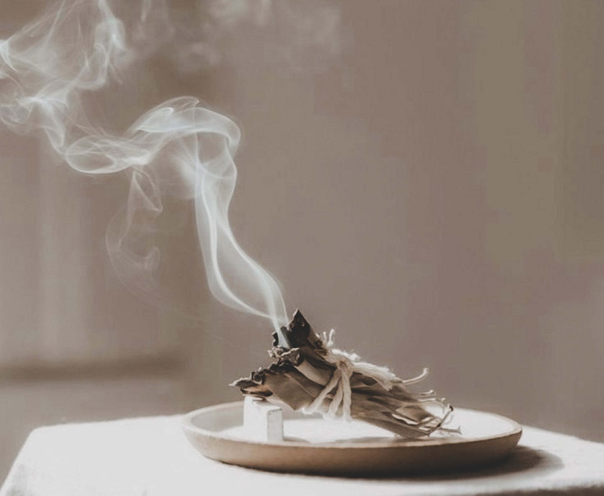 Soft earth-toned candle scene with gentle natural light — representing grounding fragrance and a calm, scent-sensitive ritual.