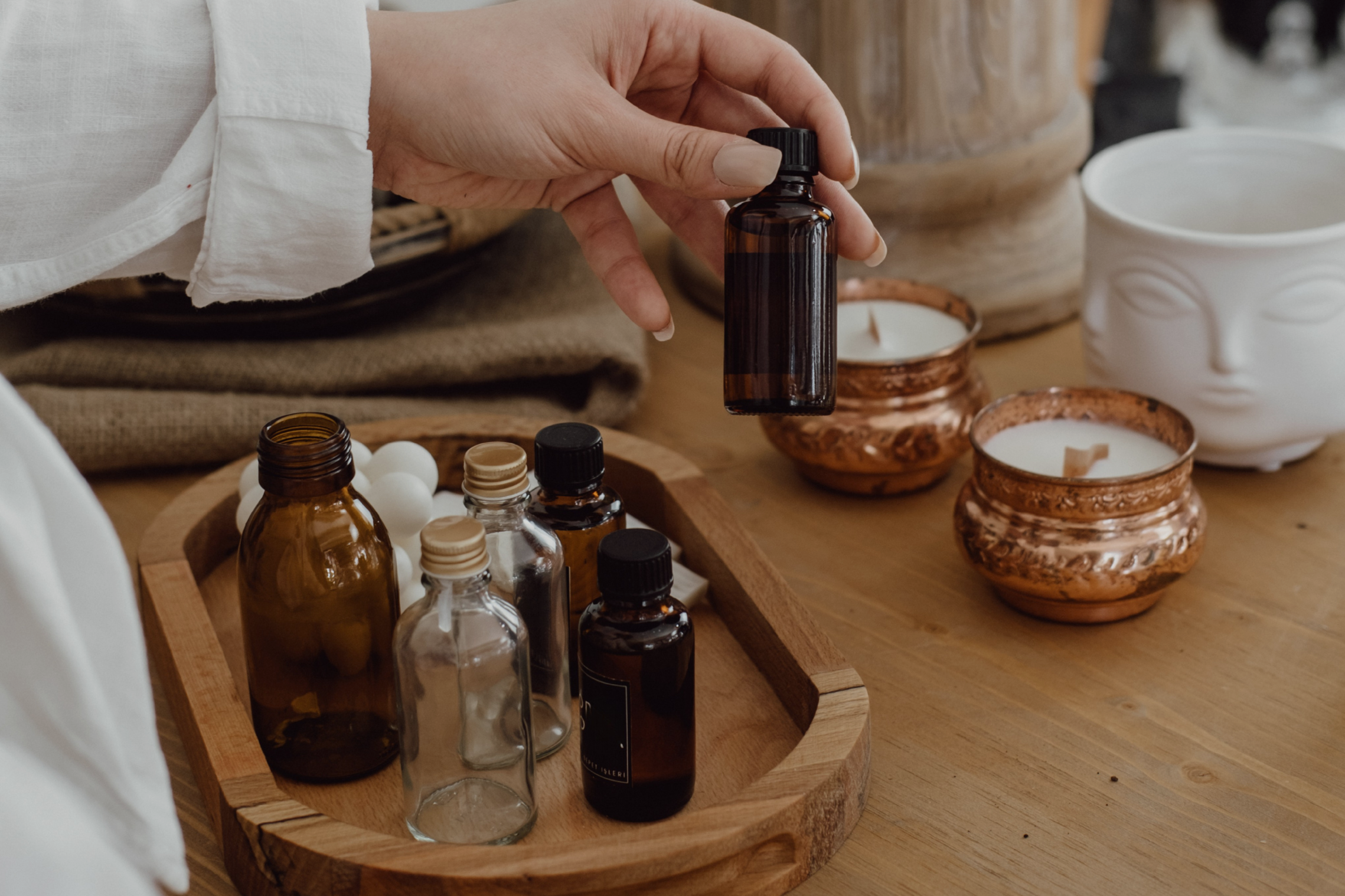 Hand-poured soy candle in an eco-friendly glass jar on a neutral background, representing clean and safe candle ingredients.