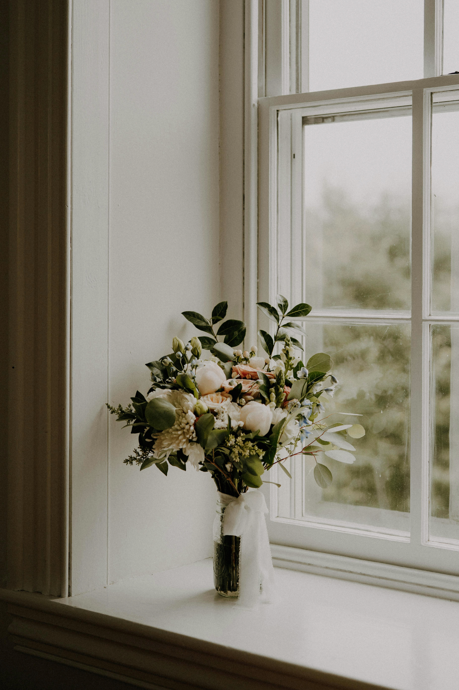 Luceria Floral collection with soft botanical inspired candle styling on window sill.