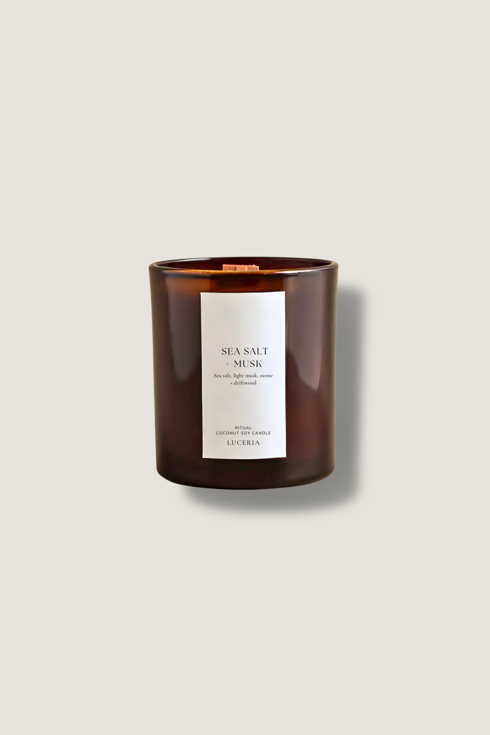 Sea salt and musk candle with a label on a beige background