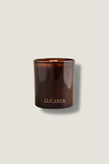 Brown candle with 'LUCERIA' branding on a light gray background