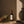 Luceria Redwoods and Moss room spray in an amber glass bottle styled with cedar wood, preserved moss, and warm natural décor.