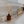 Amber glass Luceria reed diffuser bottle with wooden reed sticks on a marble surface in a bathroom setting, with text overlays detailing product features and specifications.
