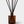 Amber glass reed diffuser bottle with black reeds and the brand name LUCERIA printed in gold on the front, set against a light gray background.