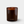 An amber glass jar candle with a light wood wick and the brand name 'LUCERIA' printed in gold near the bottom, set against a clean light gray background.