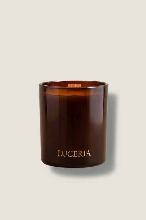 Brown candle with 'LUCERIA' branding on a light beige background