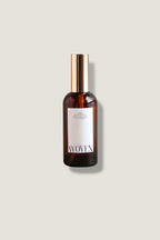 Brown bottle with gold cap and Woven label on a beige background
