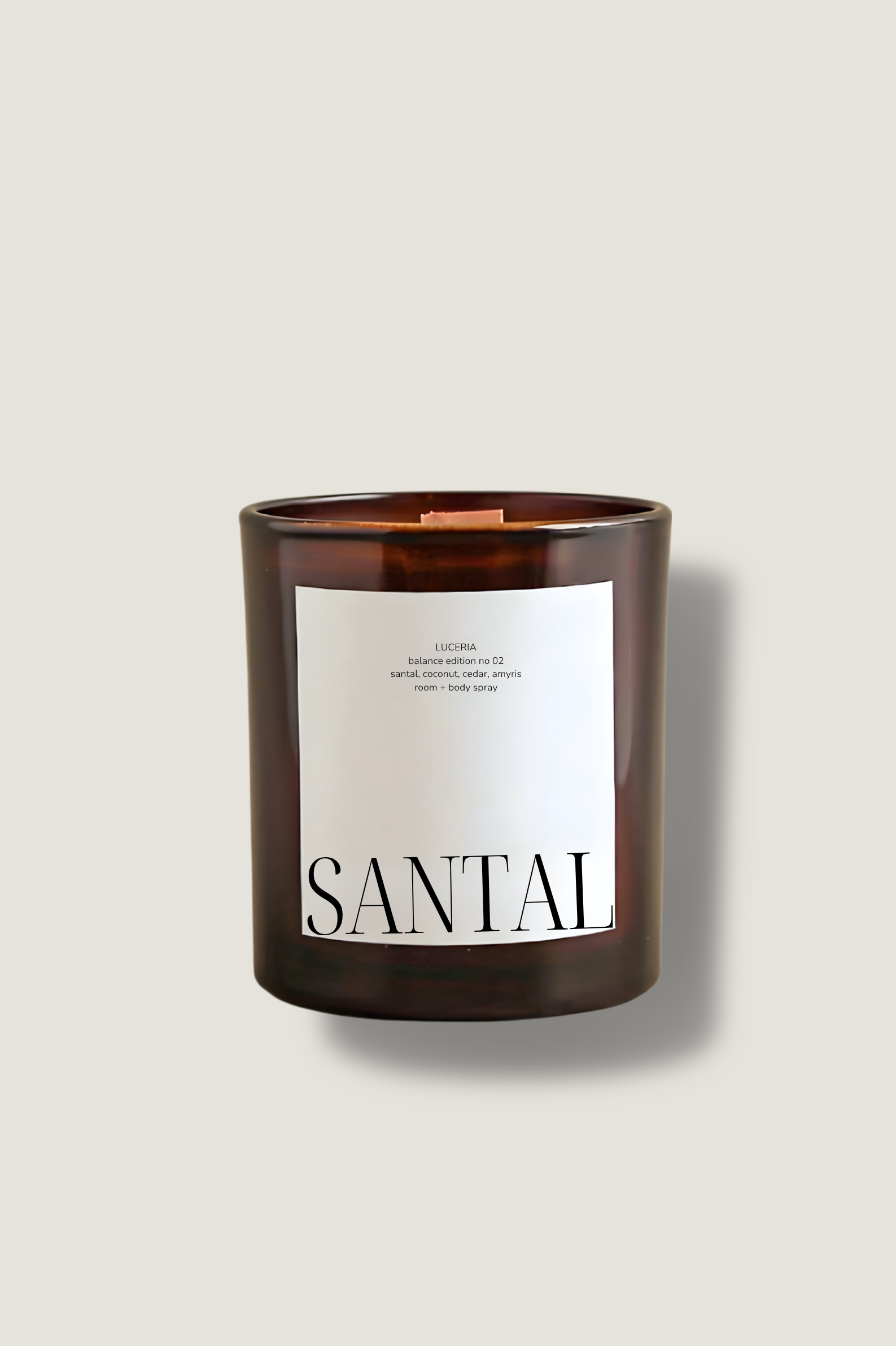 Candle with a wooden lid and 'SANTAI' label on a beige background
