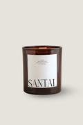 A Luceria amber glass candle jar with a white label featuring the word 'SANTAL' in black serif font, set against a solid light beige background.