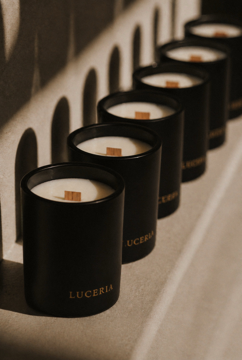Row of black Matte soy candles with LUCERIA branding