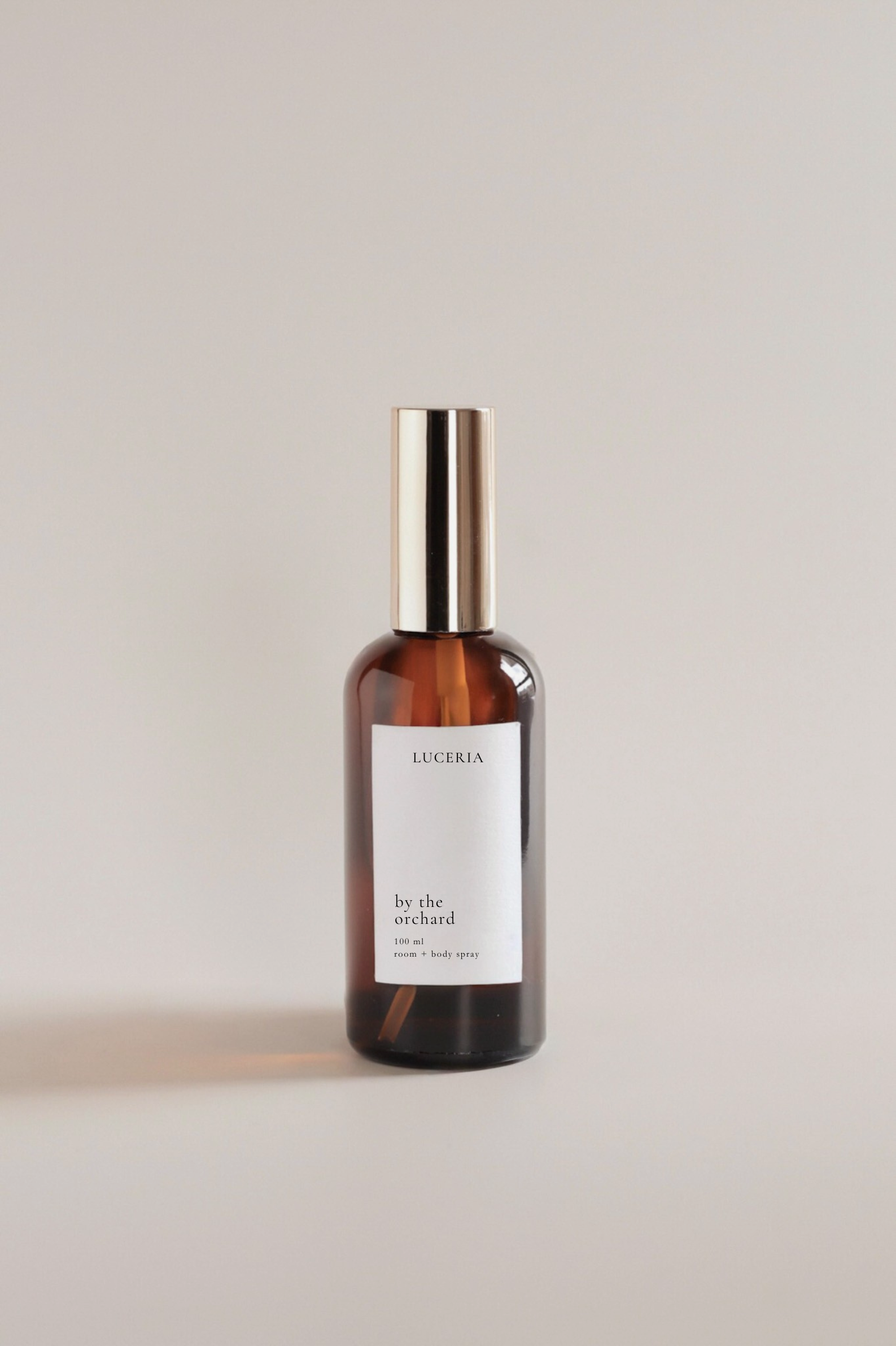 Luceria amber glass bottle with a white label on a light beige background