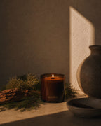 Luceria Redwoods and Moss candle with a natural wood wick styled beside cedar wood, preserved moss, and earthy neutral décor.