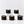 Five black Luceria scented candles with gold lettering are arranged on white pedestals against a clean white background. Three candles are lit, showing a warm flame and cream-colored wax.