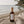 Luceria Sea Salt and Musk room spray in an amber glass bottle styled on a sandy beach with coastal grasses, linen, and ocean shoreline.