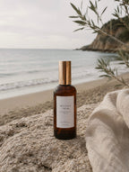 Sea salt and musk room and linen spray on beach background by Luceria Candle Co.