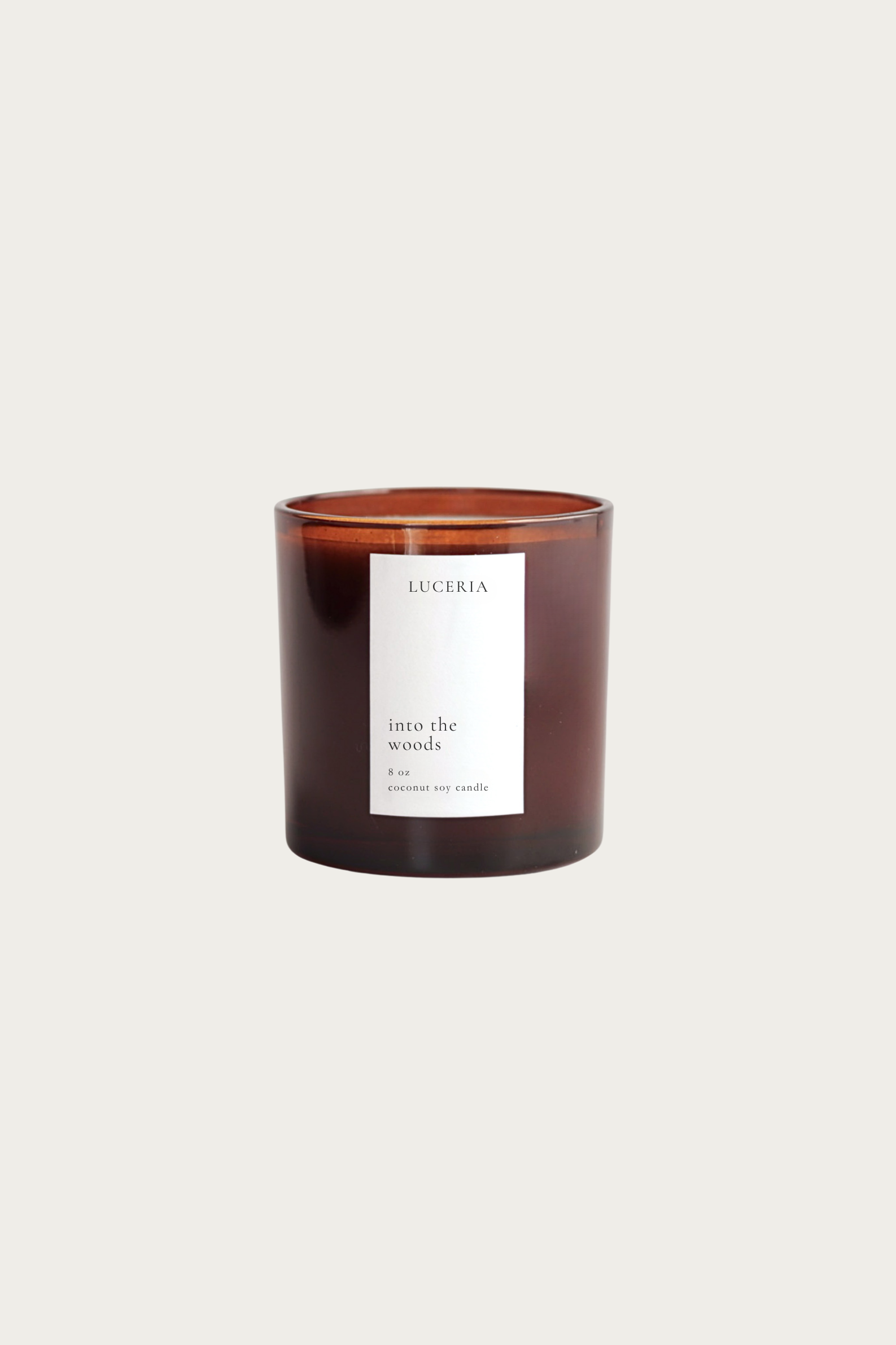 Redwoods and moss scented candle with a white label on a light beige background