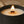 A close-up of a Luceria black candle jar with a lit wick and flame, showing cream-colored wax. Text at the top reads 'STRONG HOT THROW UP TO 90 HOURS BURN TIME'.