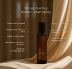 A 100 ml amber glass fragrance oil bottle with a black cap, labeled LUCERIA, set against draped beige linen fabric. White text on the image lists product features such as 'Small batch made', 'Vegan and cruelty free', and 'Phthalate free'.