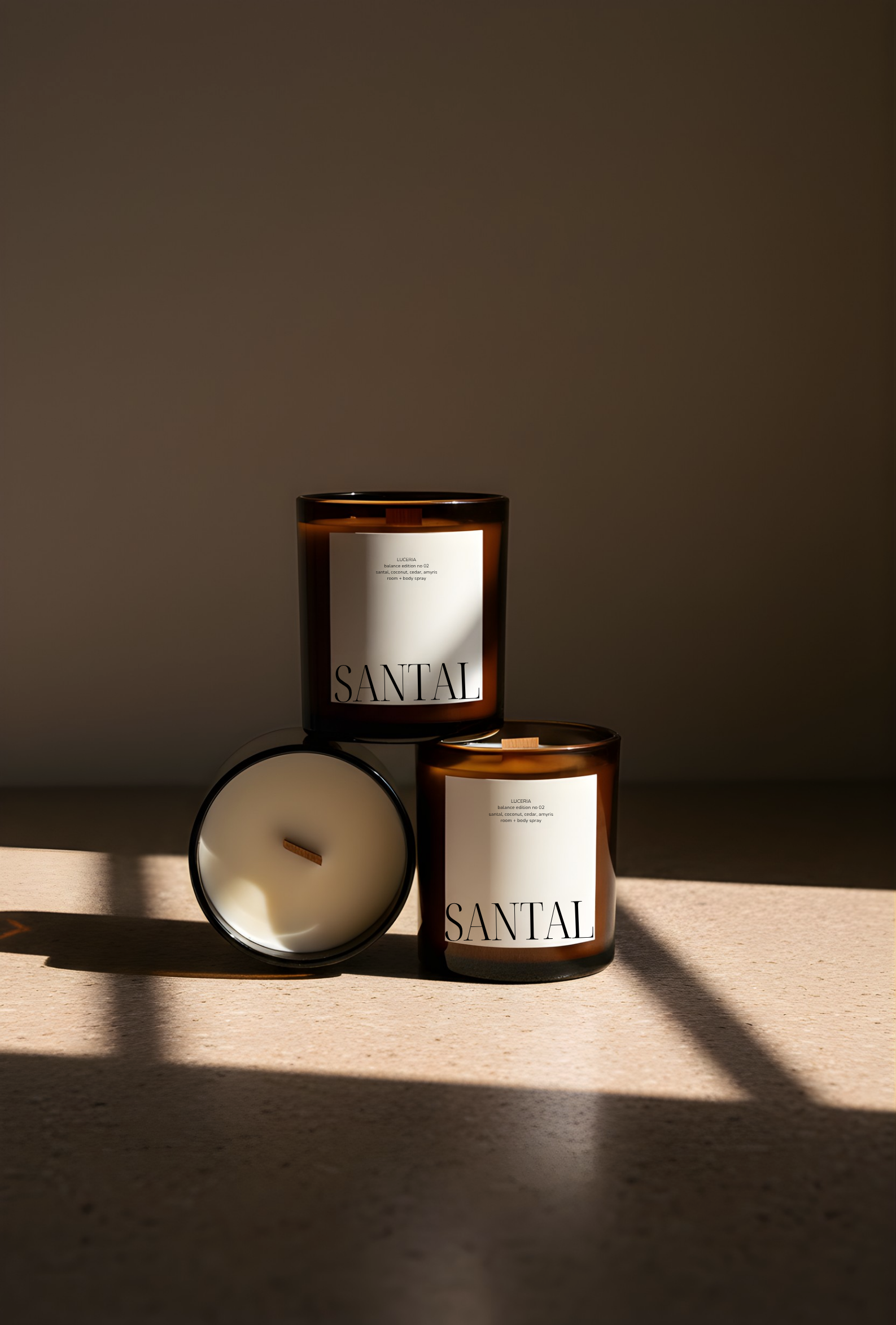 Luceria Santal candles with labels on a wooden surface and dark background