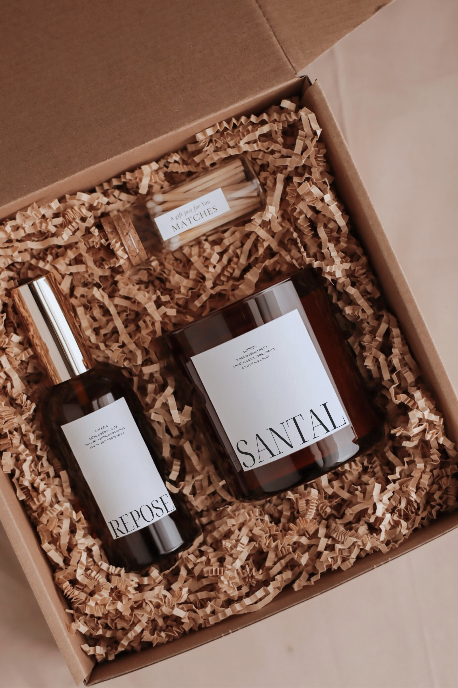 Luceria candle and spray set with labels in a box filled with shredded paper