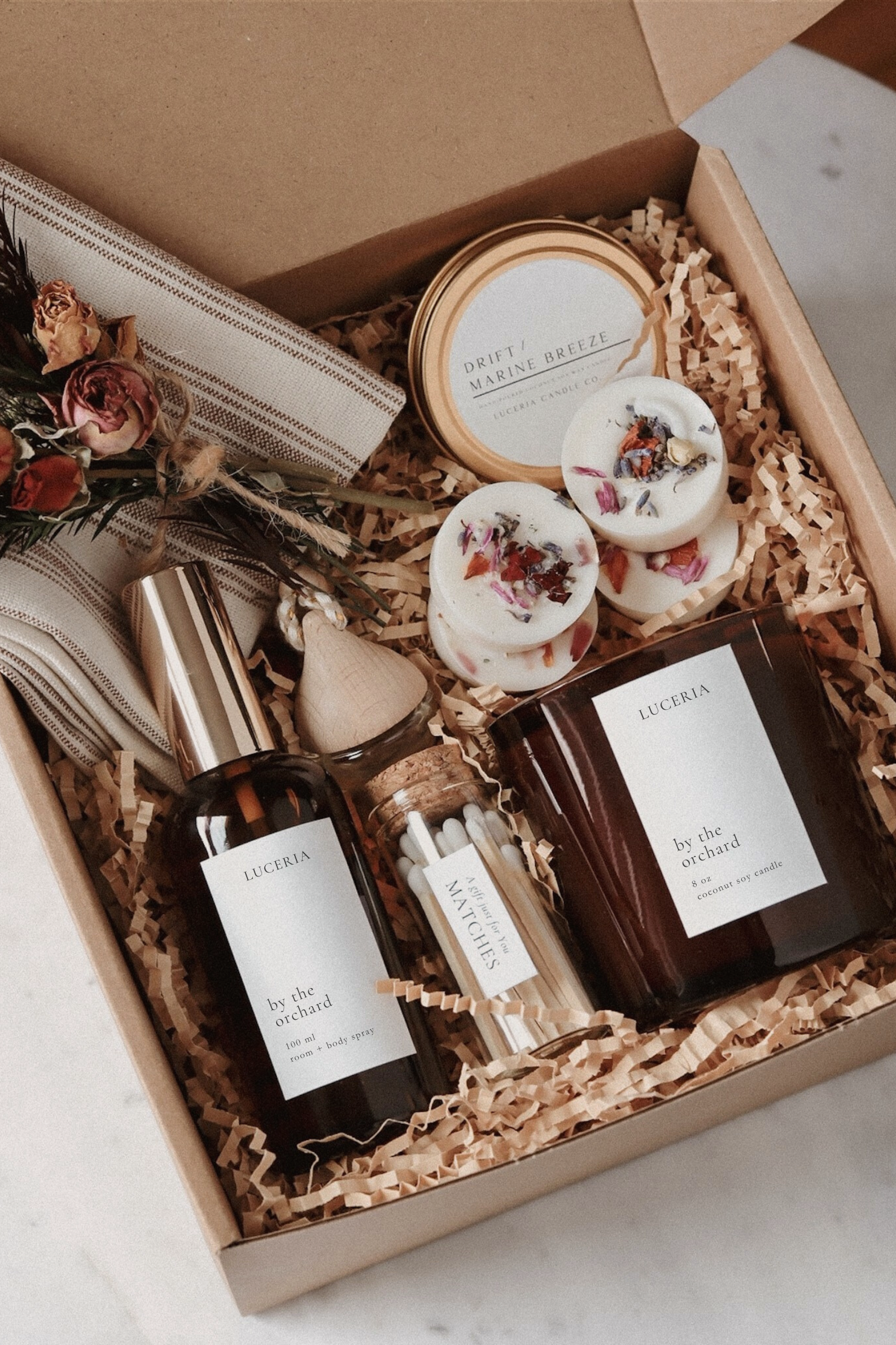 Gift set with candle products and wax melts in a curated gift box.