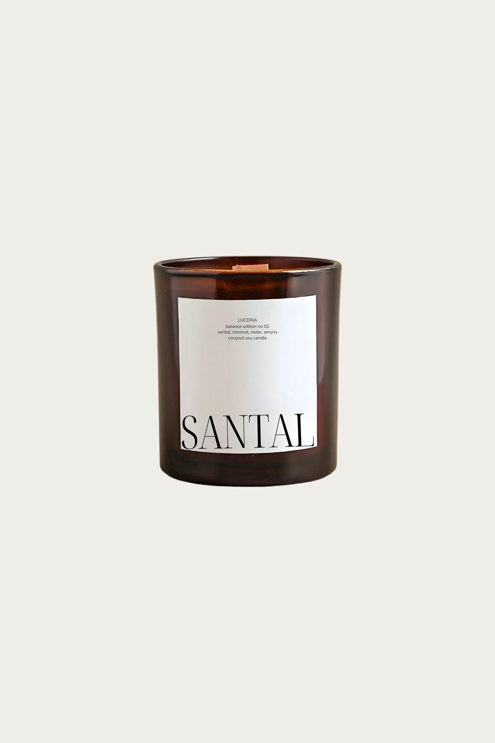 Candle with a label reading 'Santal' on a light beige background