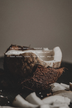 Coconut bowl with natural sandalwood on a table top dark background