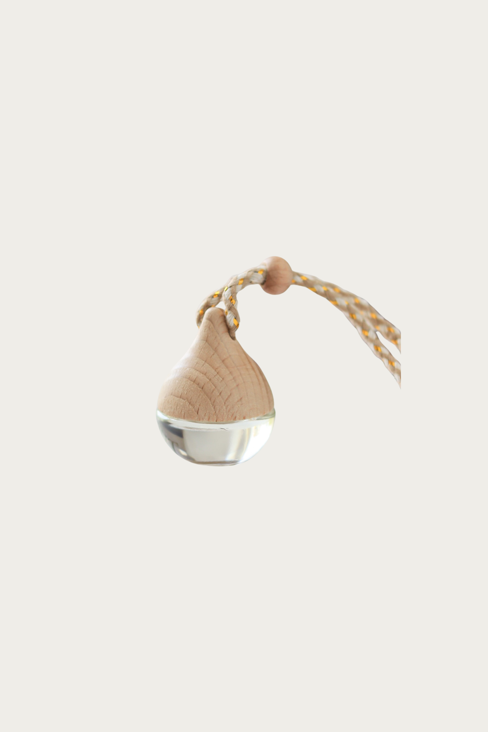 Decorative hanging ornament with a beige fabric cover and metallic base on a white background