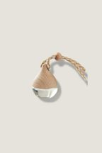 Decorative Luceria hanging diffuser with a teardrop design on a beige background