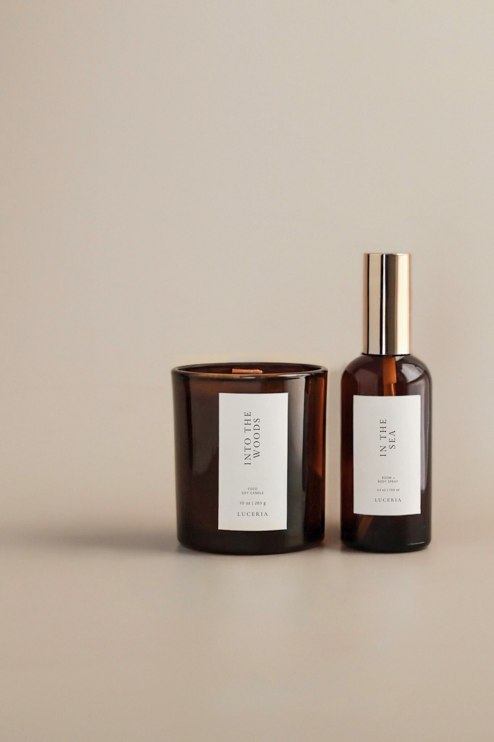 Two brown glass containers with labels on a beige background