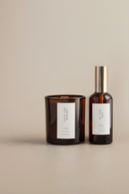 Two brown glass containers with labels on a beige background