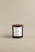Luceria's amber candle labeled 'Winter' on a beige background.
