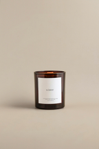 Luceria's amber candle labeled 'Winter' on a beige background.