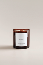 Holiday scented candle with a label reading 'winter' on a beige background