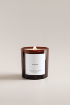 Fraser fir scented candle with a label reading 'winter' on a plain background