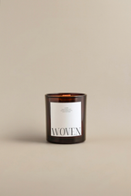 Luceria's soft Eucalyptus scented candle with 'WOVEN' label on a beige background