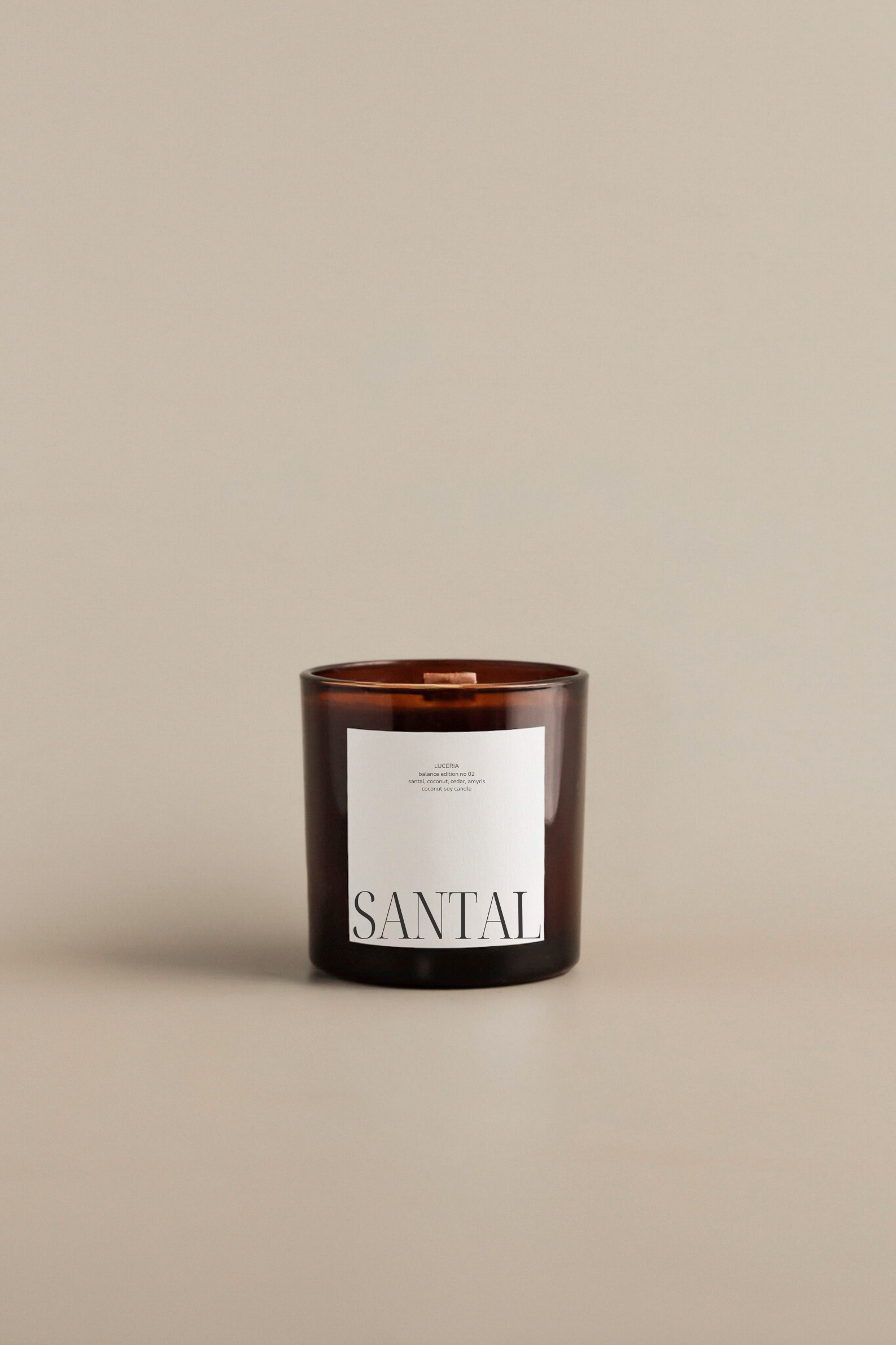 Coconut santal scented candle with 'Santal' label on a beige background