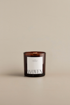 Soft Eucalyptus scented candle with 'Woven' label on a beige background by Luceria