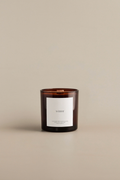 Fraser fir scented candle with a minimalist label on a beige background by Luceria