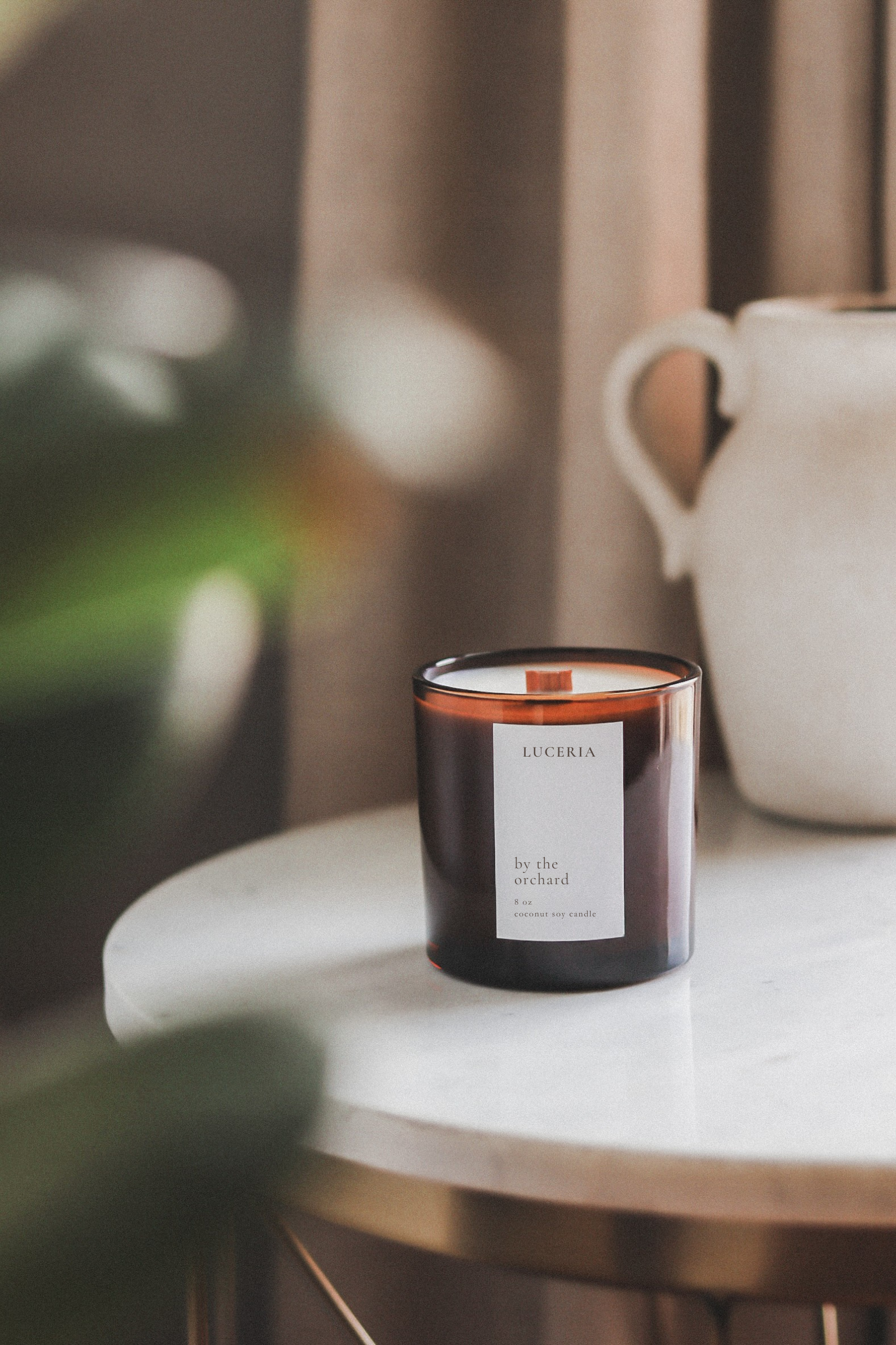 Persimmon citron scented candle by Luceria with By the Orchard label on a beige background