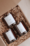 Three Luceria candle products in a box with crinkle paper. Candle trio set by Luceria Candle Co