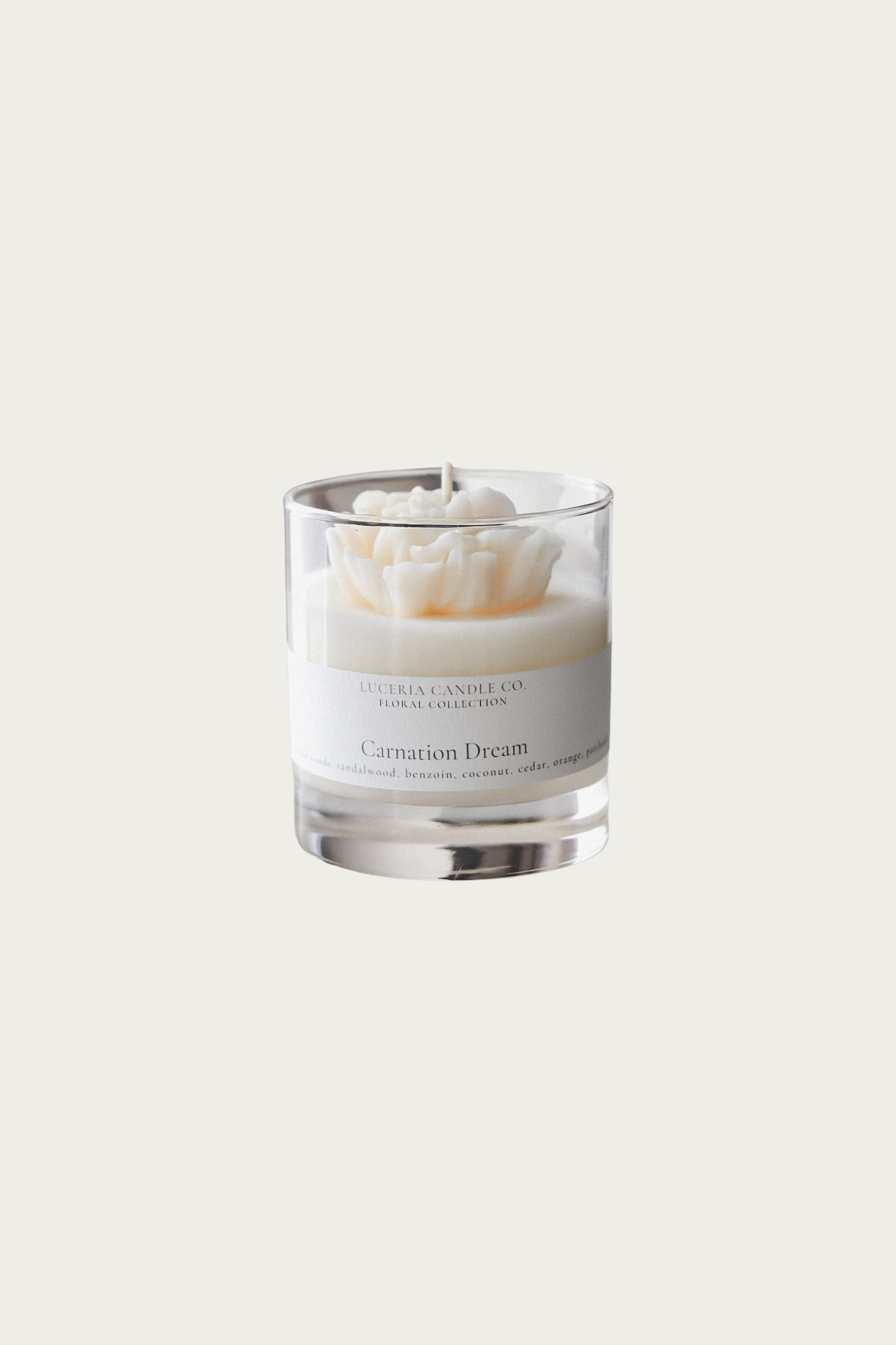 Candle in a glass jar with a label on a white background