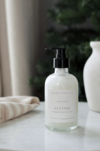 Hand soap bottle labeled 'Cleanse' on a surface with a blurred background