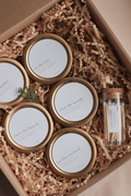 Set of small Luceria candles with gold lids in a box with crinkle paper