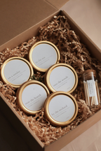 Set of Luceria discovery set candles in a Kraft box with crinkled paper and matches