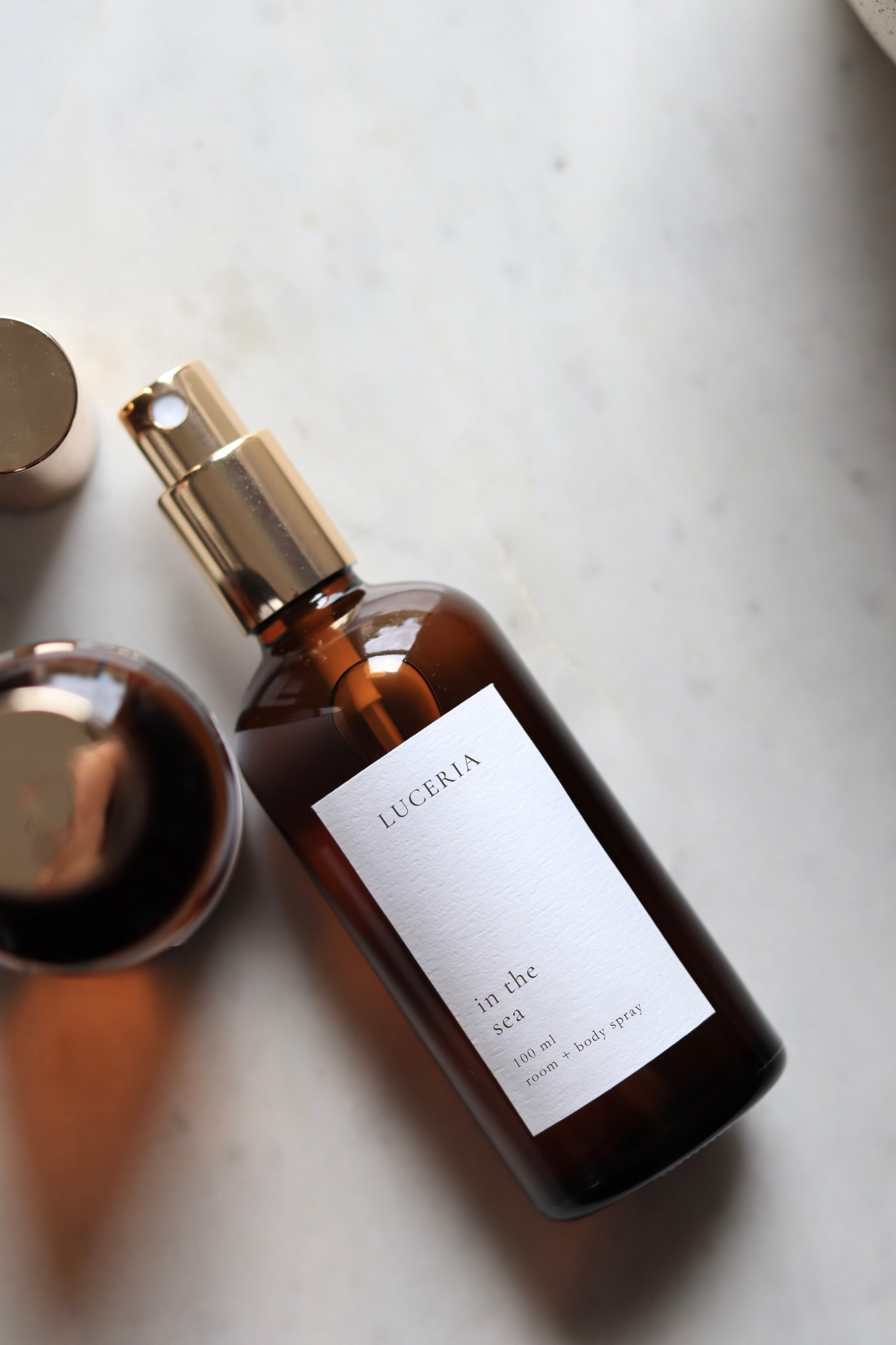 Brown bottle with gold cap labeled 'Luceria' on a light surface