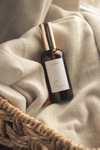 Bottle of Luceria perfume on a textured fabric background